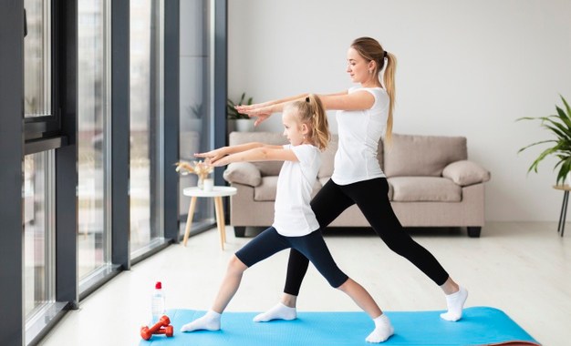 mother-exercising-along-with-child-home